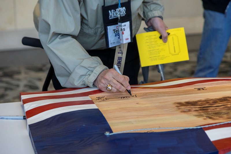 NRA Foundation Banquet and Auction signing American flag